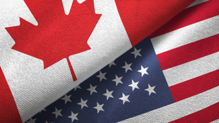 The Canadian and American flag overlapping each other