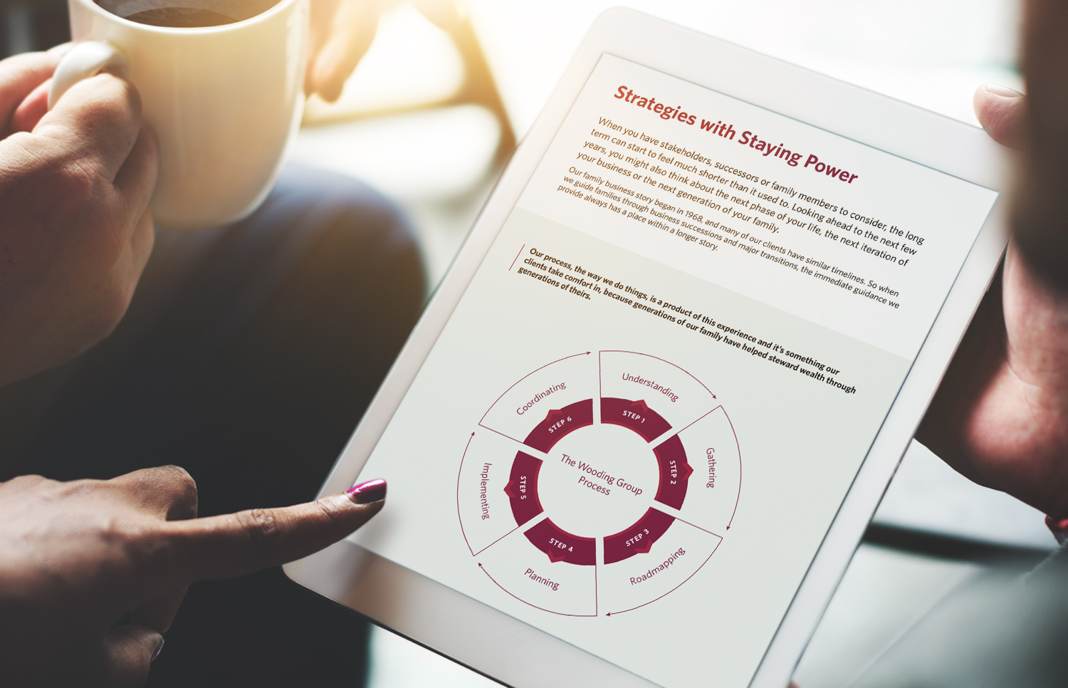 Hand pointing to graphic with text on a tablet